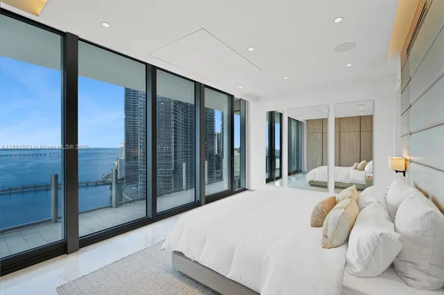 a bedroom with bed and glass door