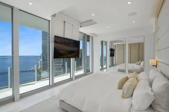 a bedroom with furniture and a flat screen tv