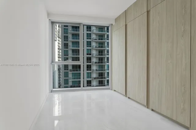 a bathroom with a sink shower and a mirror