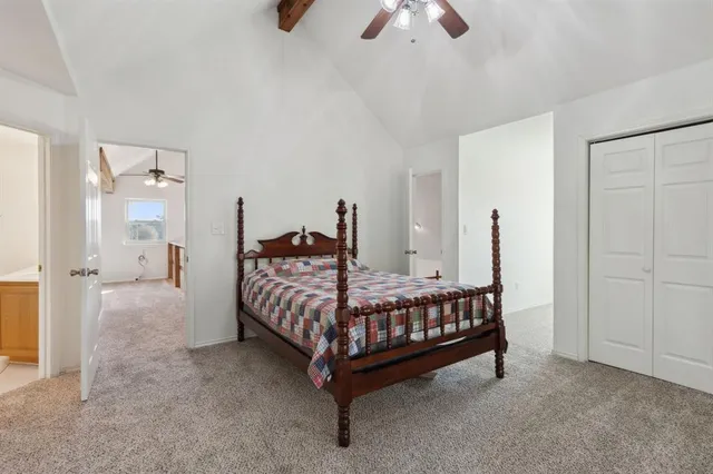 a room with a bed window and a chandelier