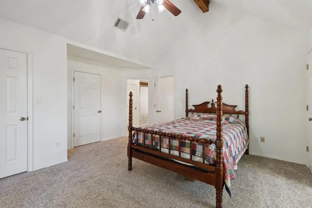a bed sitting in a room with a chandelier