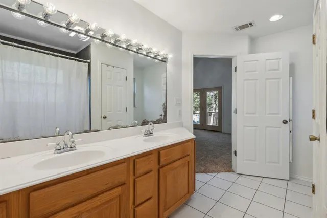 a bathroom with a sink double vanity and a mirror