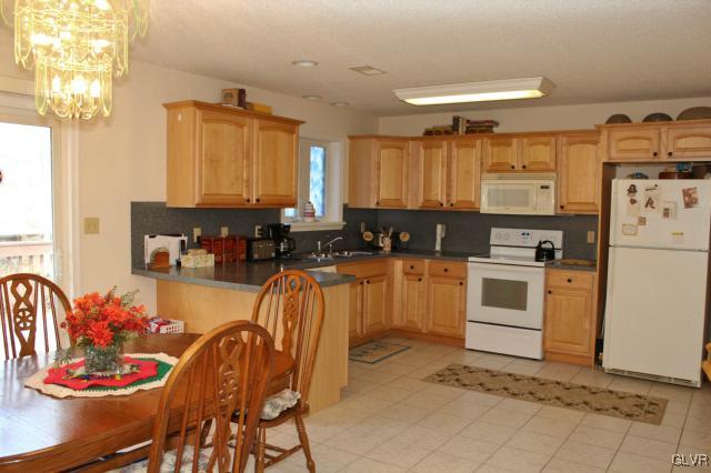 154 Ash Lane Kunkletown, PA 18058 - Photo 2 of 20 a kitchen with a refrigerator and cabinets