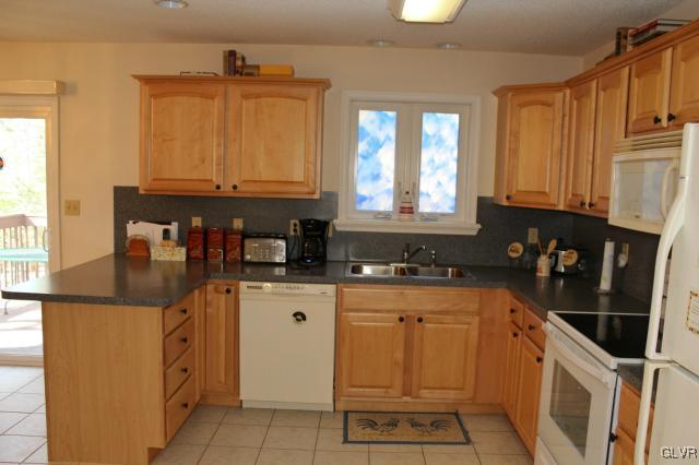 154 Ash Lane Kunkletown, PA 18058 - Photo 3 of 20 a kitchen with granite countertop a sink a stove and cabinets