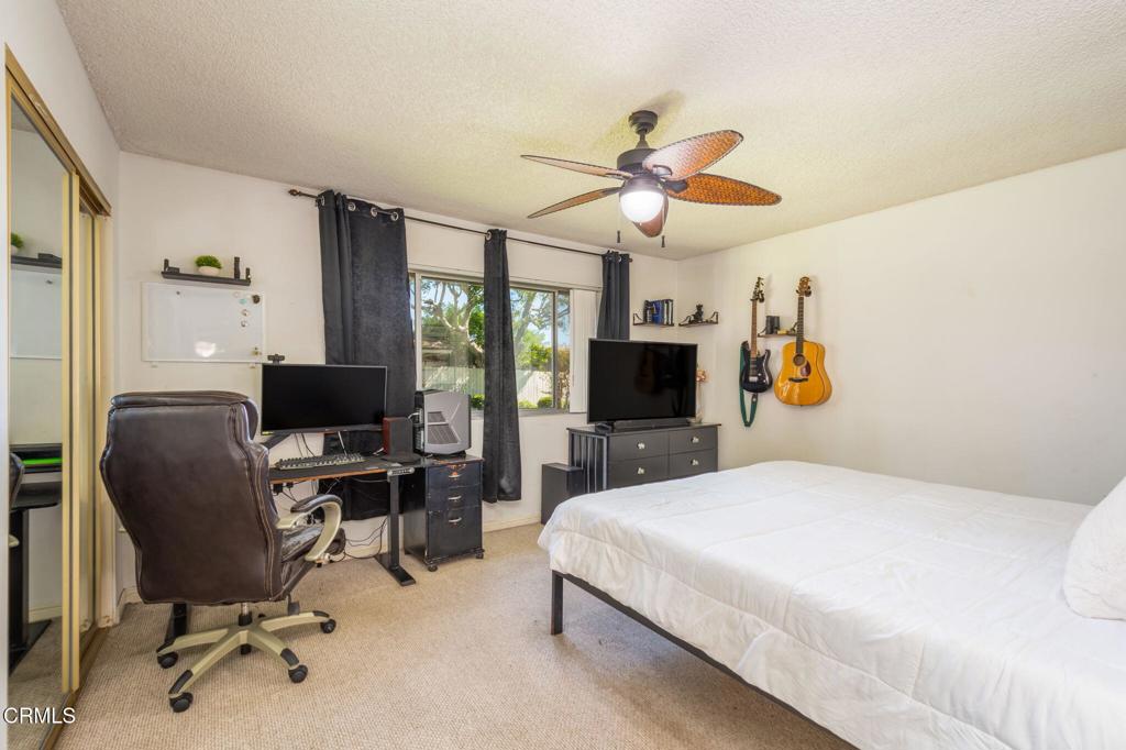 3610 Isle Way Oxnard, CA 93035 - Photo 13 of 25 a bedroom with a bed a computer on a desk and chair