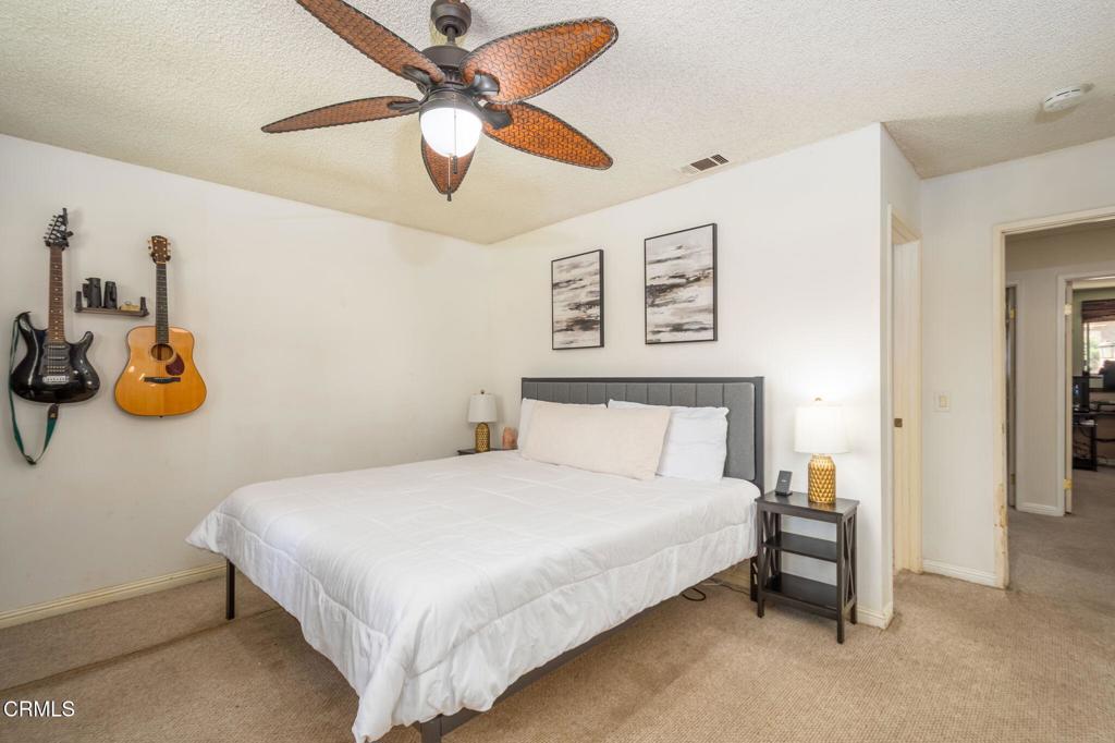 3610 Isle Way Oxnard, CA 93035 - Photo 14 of 25 a bedroom with a bed and a chandelier