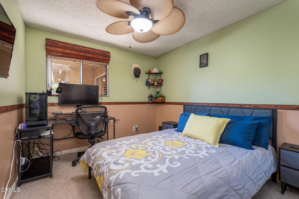 3610 Isle Way Oxnard, CA 93035 - Photo 17 of 25 a bedroom with a bed and a chandelier