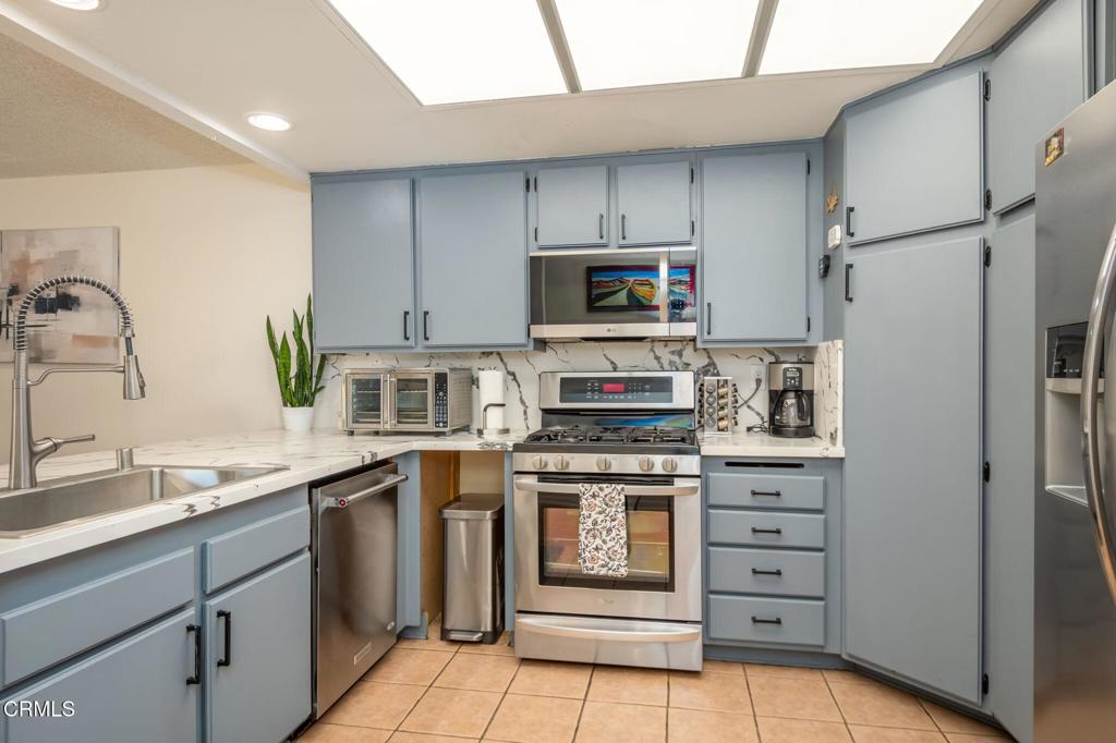 3610 Isle Way Oxnard, CA 93035 - Photo 9 of 25 a kitchen with stainless steel appliances a stove sink and refrigerator