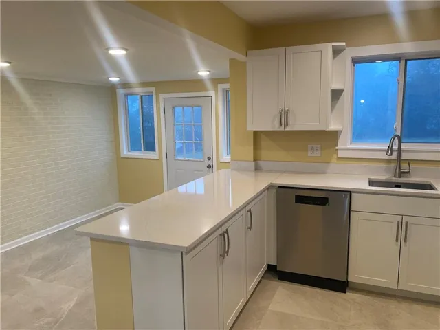 a kitchen with a sink cabinets and window