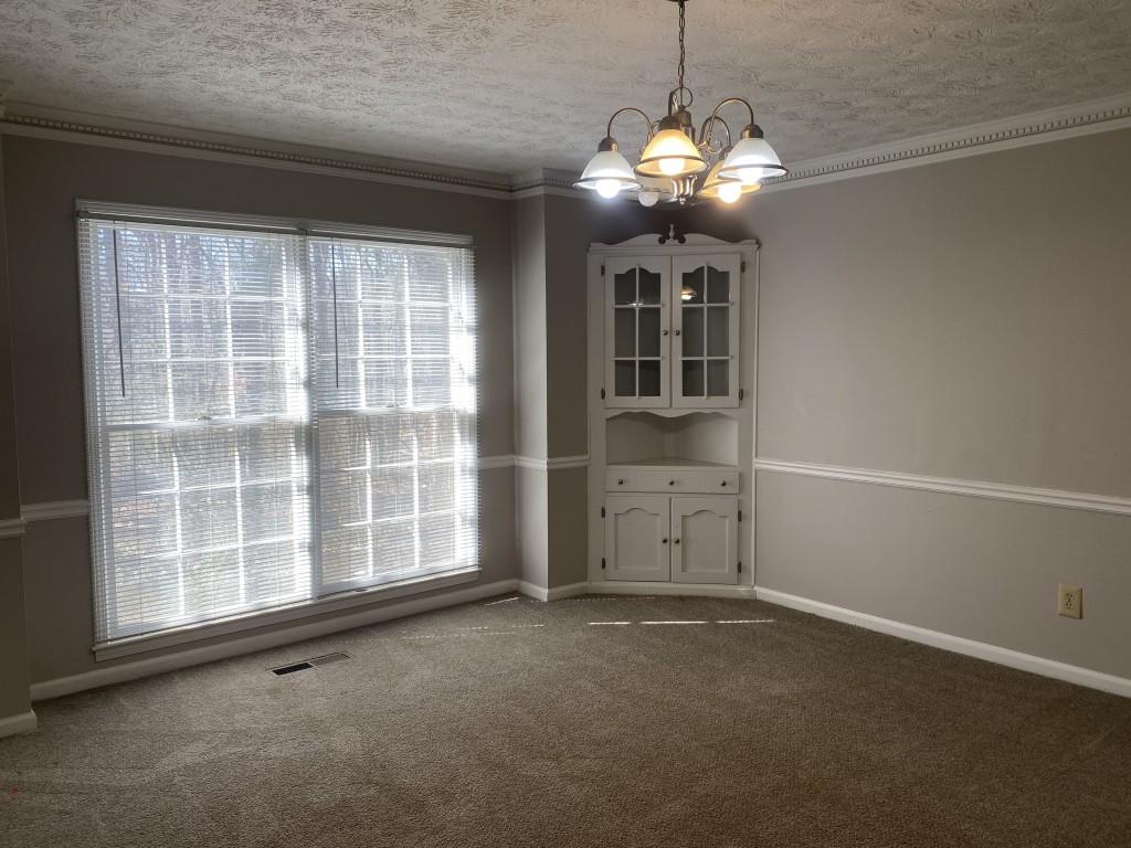 1720 Ridgefield Drive Roswell, GA 30075 - Photo 11 of 35 a view of a livingroom with a chandelier fan and a window