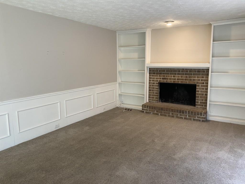 1720 Ridgefield Drive Roswell, GA 30075 - Photo 3 of 35 a view of an empty room with a fireplace