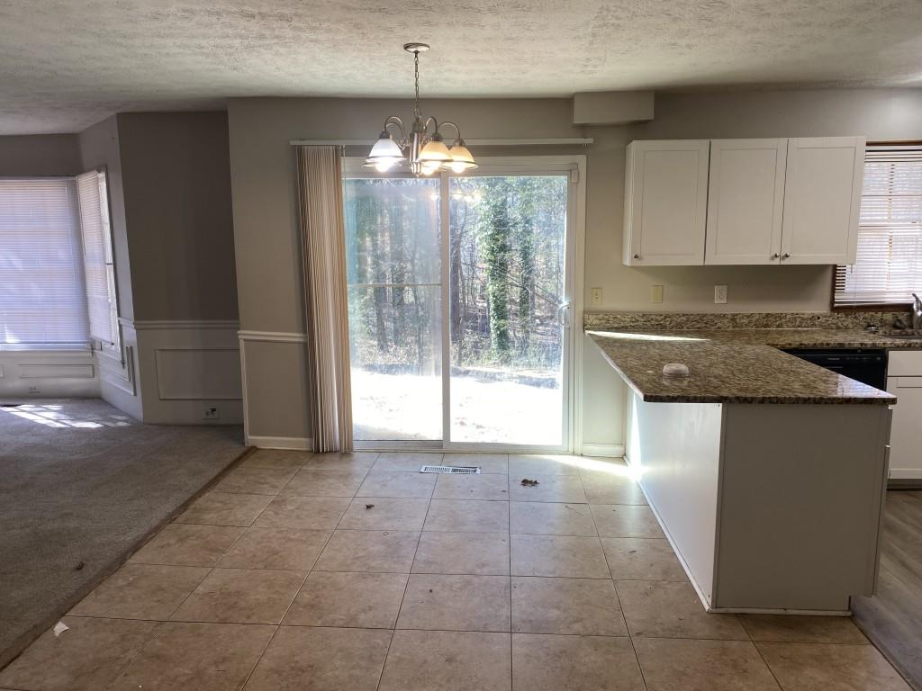 1720 Ridgefield Drive Roswell, GA 30075 - Photo 4 of 35 a view of a kitchen with granite countertop cabinets and a counter top space