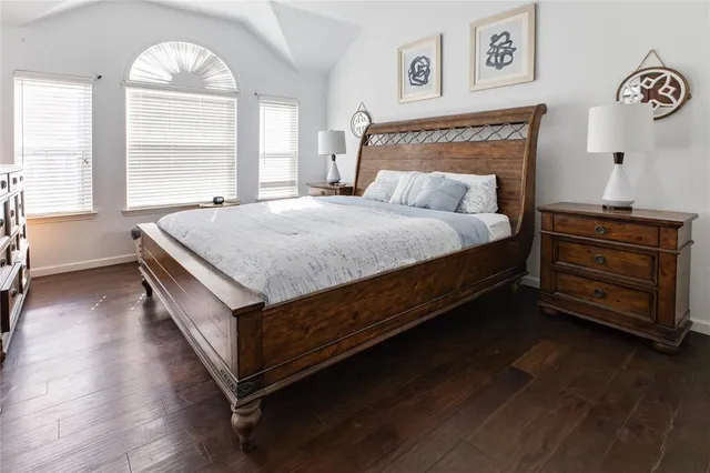 a bed sitting in a bedroom next to a window