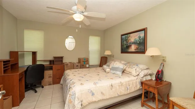a bedroom with bed and a chandelier