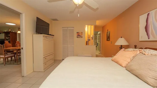 a spacious bedroom with a bed and a chandelier