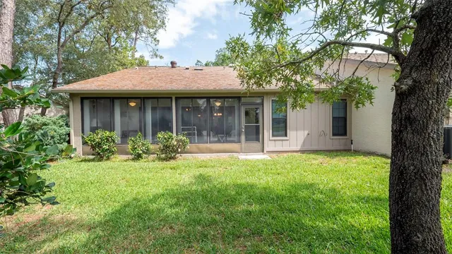 a front view of a house with a garden and yard