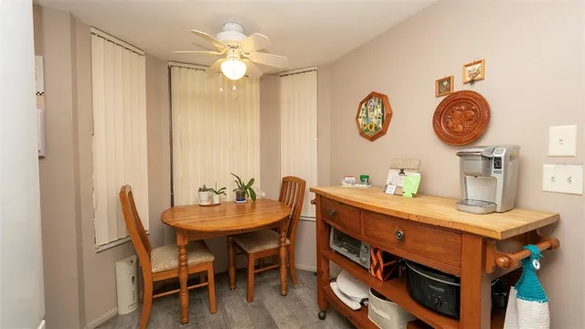 a dining room with a wooden table and chairs