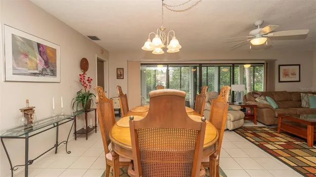 a living room with furniture chandelier and a large window