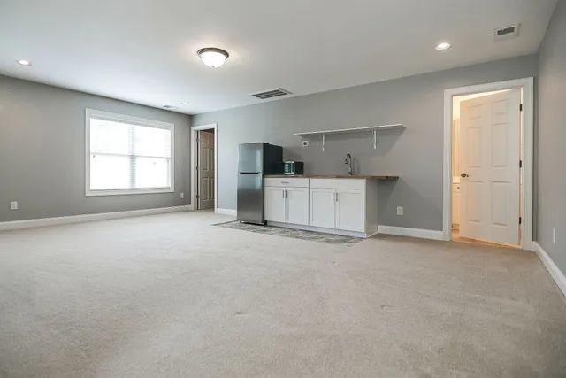 an empty room with a empty space and windows