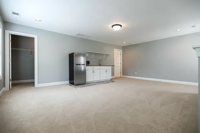 a view of an empty room with a kitchen