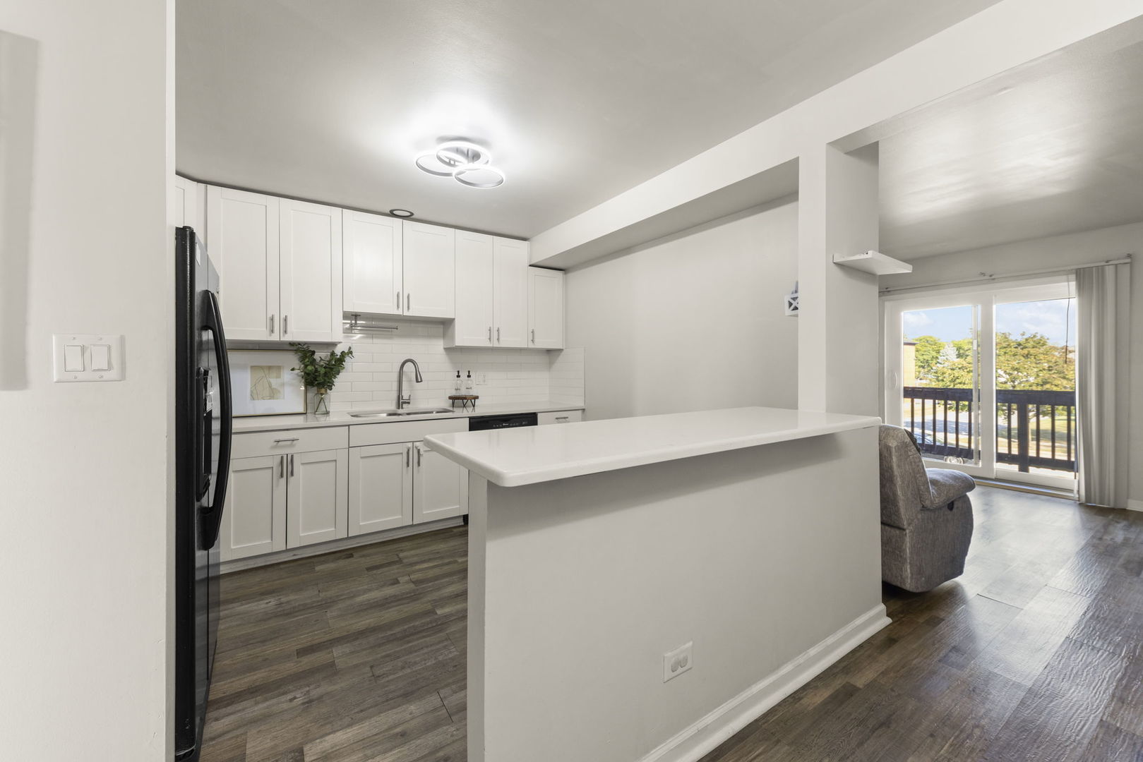 1002 Spruce Street, Unit 2B Glendale Heights, IL 60139 - Photo 6 of 16 a kitchen with a refrigerator a stove a sink dishwasher and a oven with wooden floor