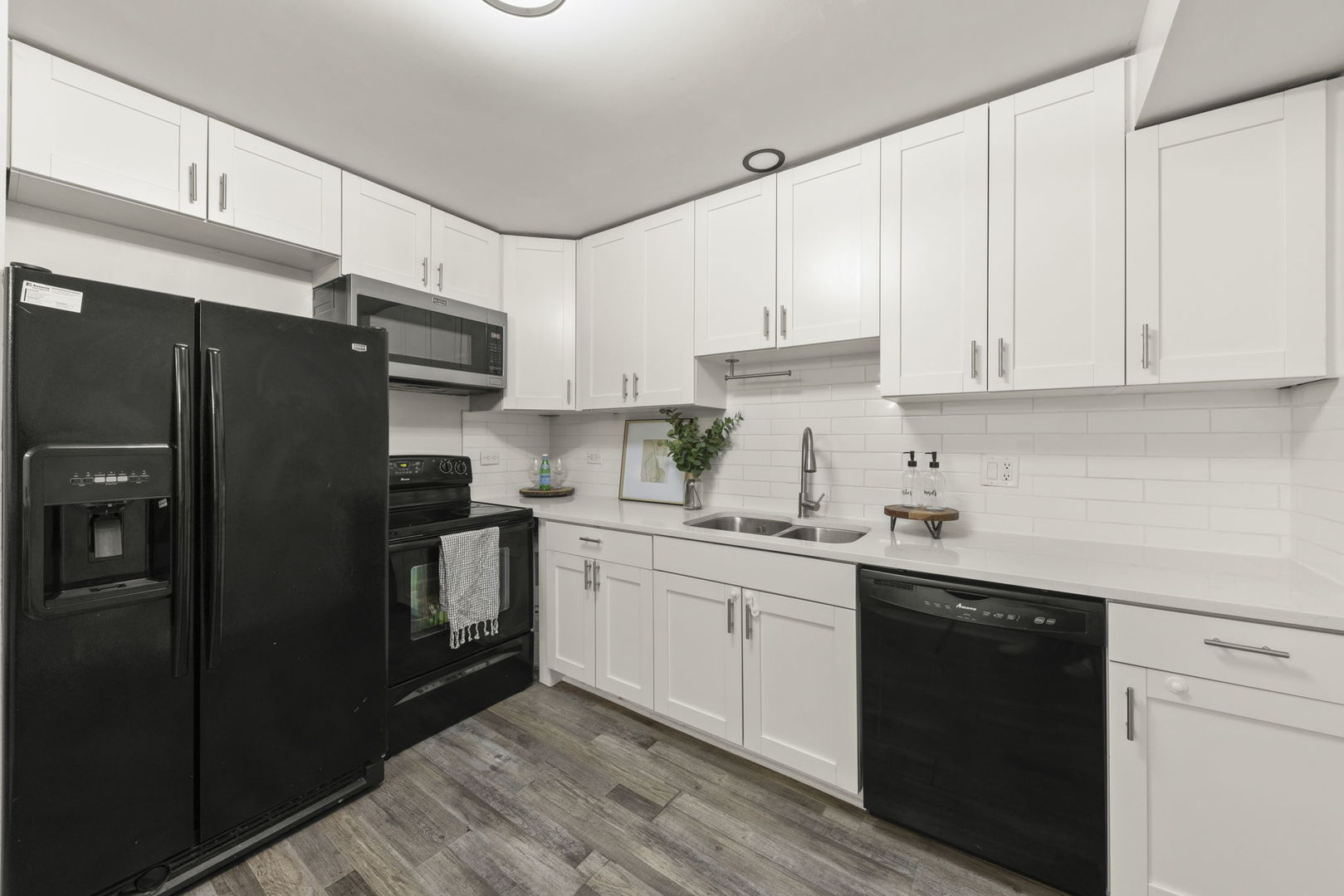 1002 Spruce Street, Unit 2B Glendale Heights, IL 60139 - Photo 8 of 16 a kitchen with a sink a refrigerator and cabinets