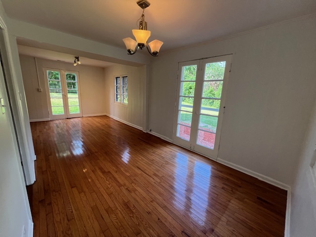 14935 West Old School Road, Unit 2 Libertyville, IL 60048 - Photo 11 of 32 a view of an empty room with wooden floor and a window