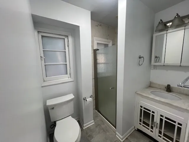 a bathroom with a toilet sink and shower