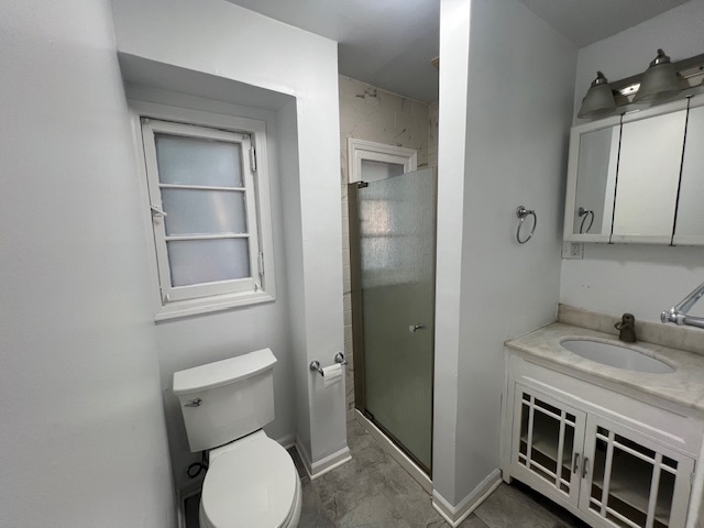 14935 West Old School Road, Unit 2 Libertyville, IL 60048 - Photo 14 of 32 a bathroom with a toilet sink and shower