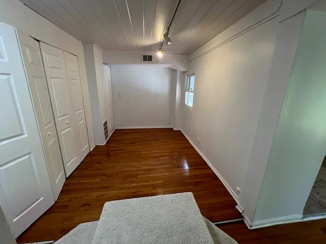 a view of hallway with wooden floor