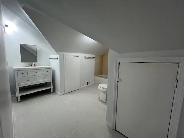 a view of an empty room with a fireplace