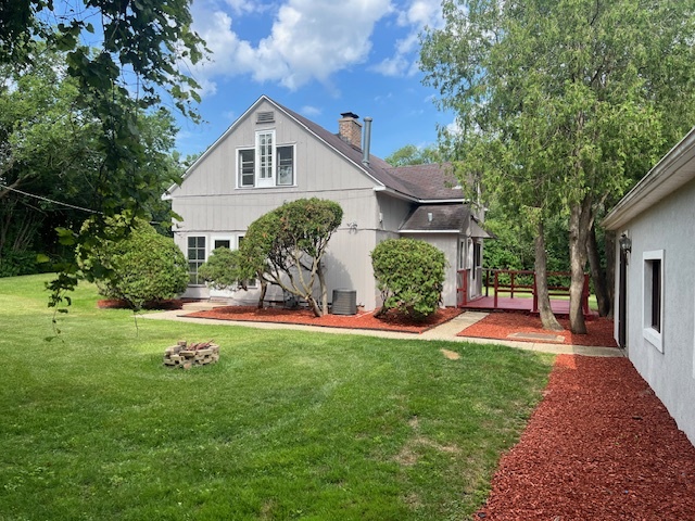 14935 West Old School Road, Unit 2 Libertyville, IL 60048 - Photo 29 of 32 a front view of a house with a yard and porch