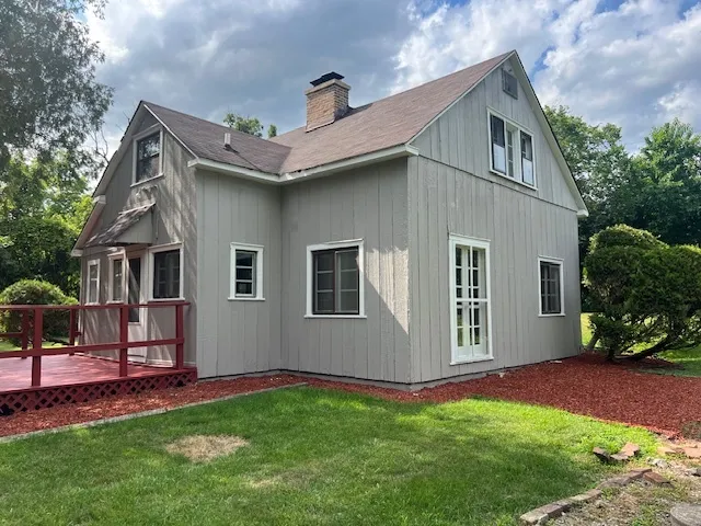 a front view of house with yard and green space