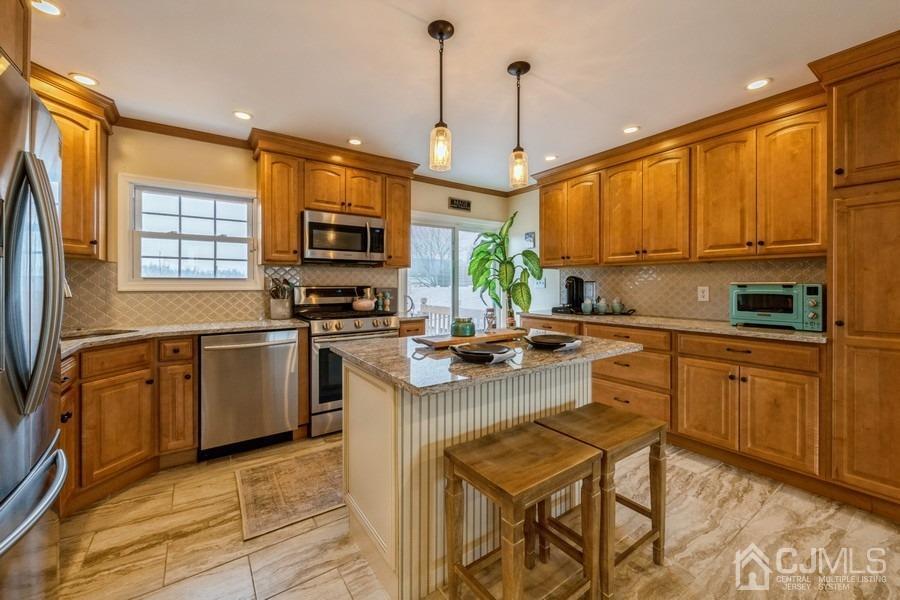 35 Pine Tree Drive Colonia, NJ 07067 - Photo 13 of 39 a kitchen with a sink a counter top space appliances and cabinets