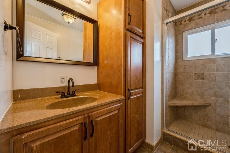 35 Pine Tree Drive Colonia, NJ 07067 - Photo 18 of 39 a bathroom with a sink and a mirror