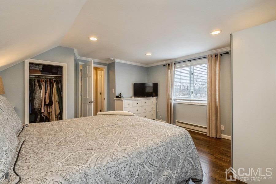 35 Pine Tree Drive Colonia, NJ 07067 - Photo 20 of 39 a bed room with a bed a television and a window