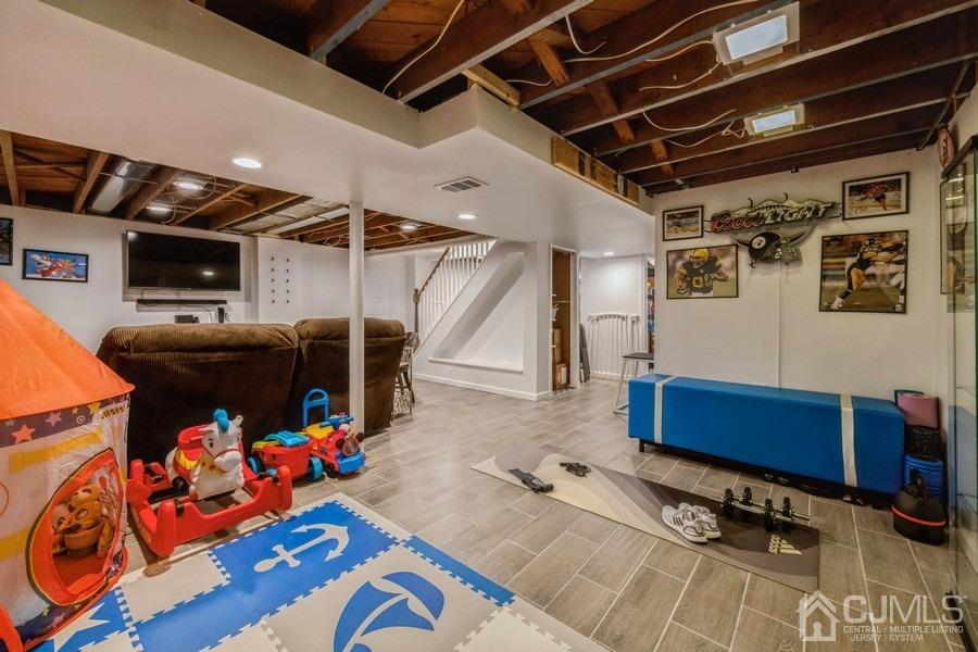 35 Pine Tree Drive Colonia, NJ 07067 - Photo 25 of 39 a view of gym equipment and a projector screen