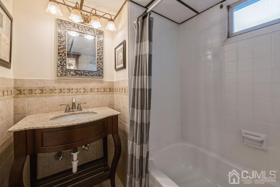 35 Pine Tree Drive Colonia, NJ 07067 - Photo 27 of 39 a bathroom with a sink and a mirror