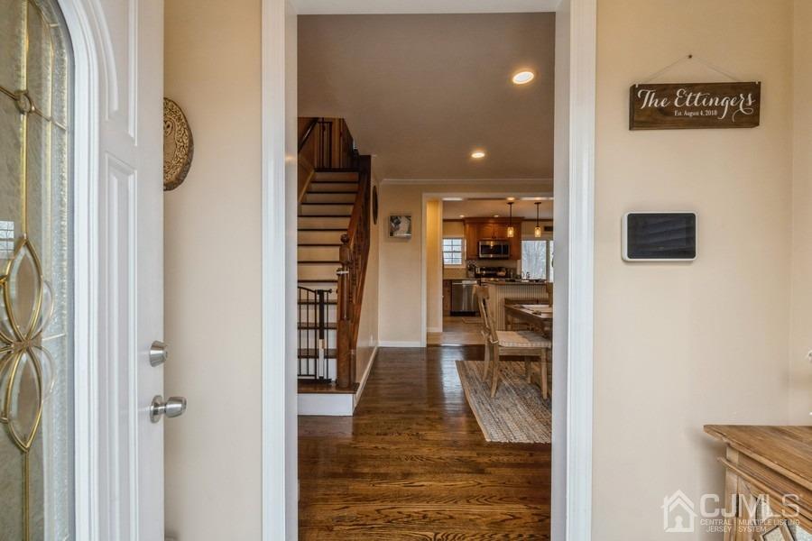 35 Pine Tree Drive Colonia, NJ 07067 - Photo 5 of 39 a view of a hallway with wooden floor and dining room