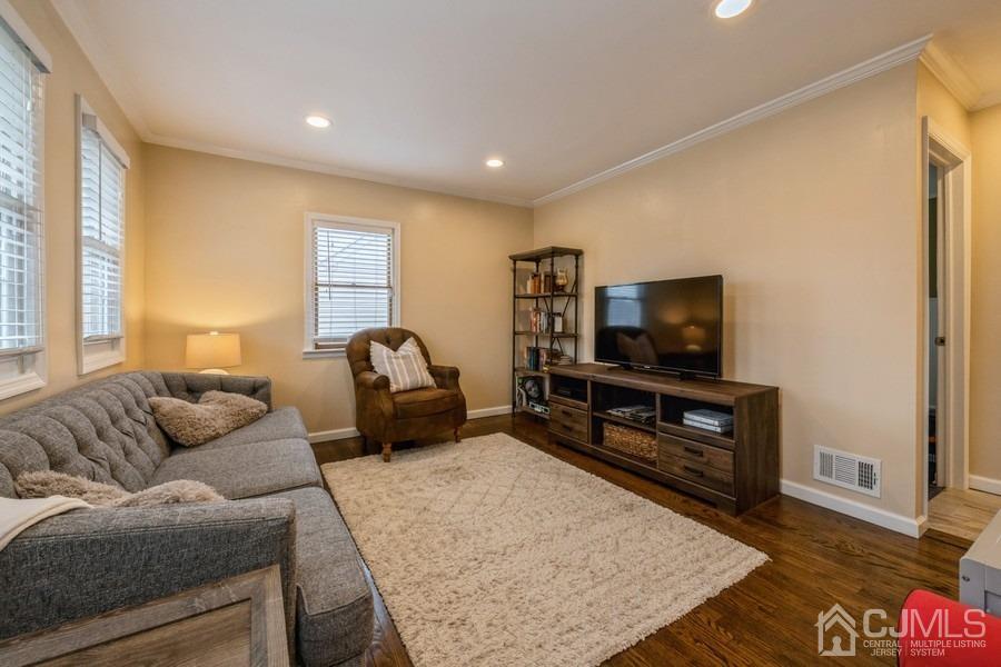 35 Pine Tree Drive Colonia, NJ 07067 - Photo 10 of 39 a living room with furniture and a flat screen tv