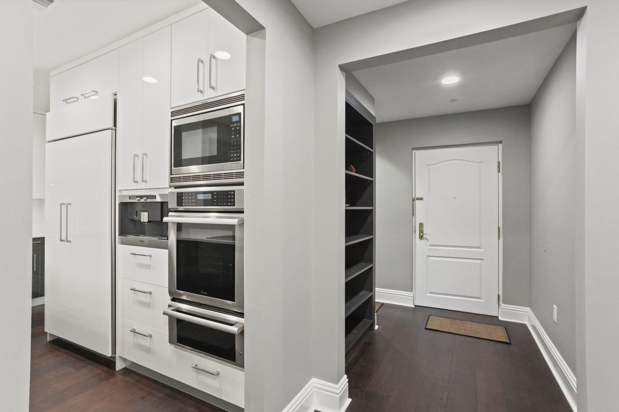 200 East Palmetto Park Road, Unit 10 Boca Raton, FL 33432 - Photo 13 of 47 a kitchen with white cabinets and stainless steel appliances