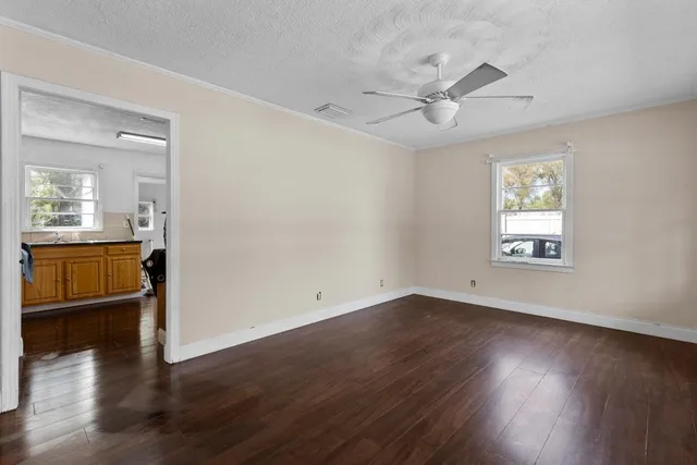 wooden floor in an empty room with a window