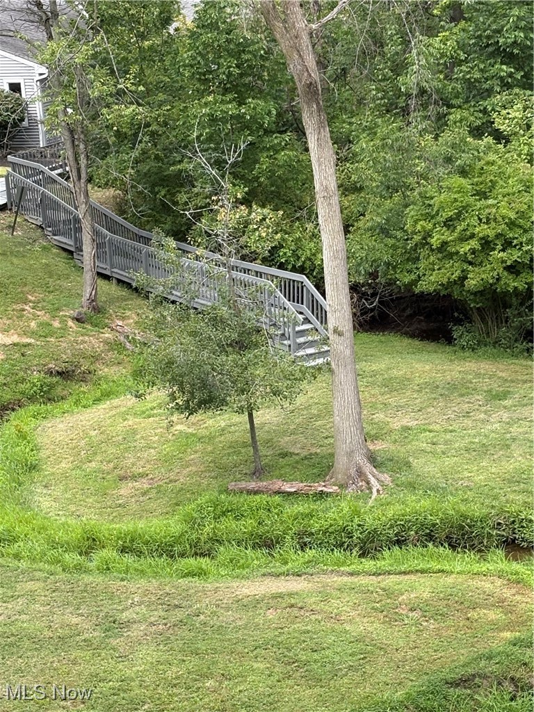 4750 Oak Point Road, Unit 302 Lorain, OH 44053 - Photo 20 of 25 View from condo of bridge across the creek in the backyard. Imagine those trees in the fall!