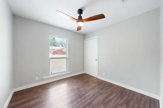 wooden floor in an empty room with a window