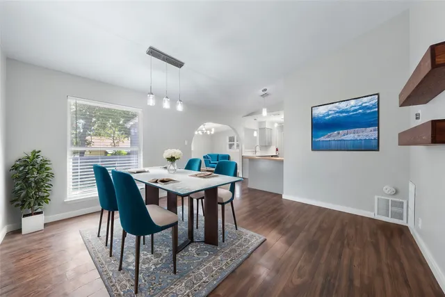 a view of a dining room with furniture and wooden floor