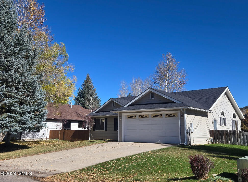 702 Bull Run Eagle, CO 81631 - Photo 1 of 26 a front view of a house with a yard and garage