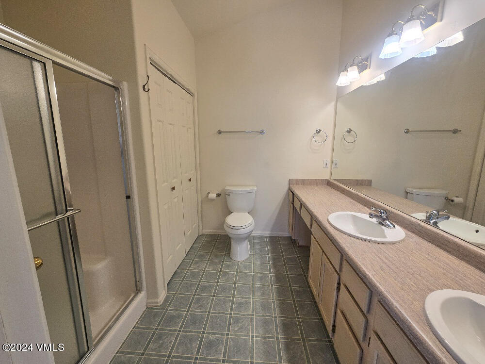 702 Bull Run Eagle, CO 81631 - Photo 17 of 26 a bathroom with a sink a toilet a mirror and shower