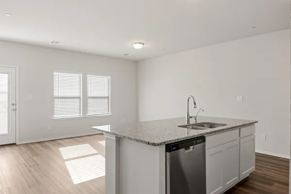 a kitchen with stainless steel appliances granite countertop a sink and a window