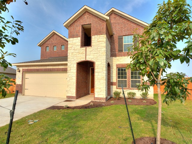 2201 Blended Tree Ranch Drive Leander, TX 78641 - Photo 1 of 1 a front view of a house with a yard