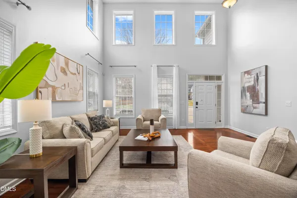 a living room with furniture potted plant and a window